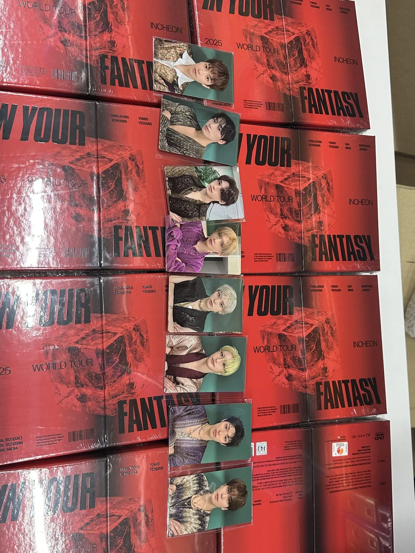 K-pop albums and preorder benefit photocards arranged for an arrival check in