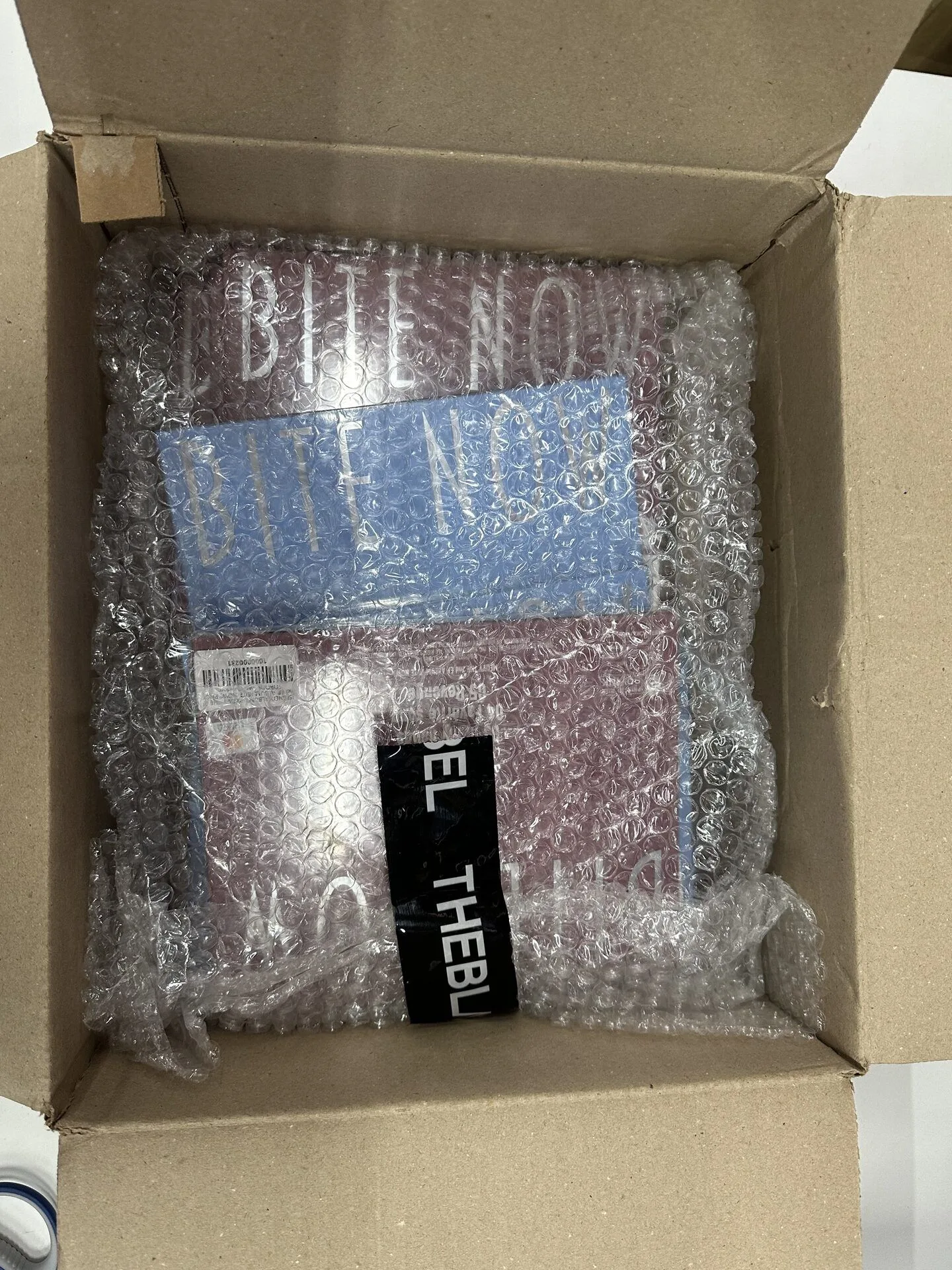 Multiple opened cartons containing protected K-pop products for consolidation