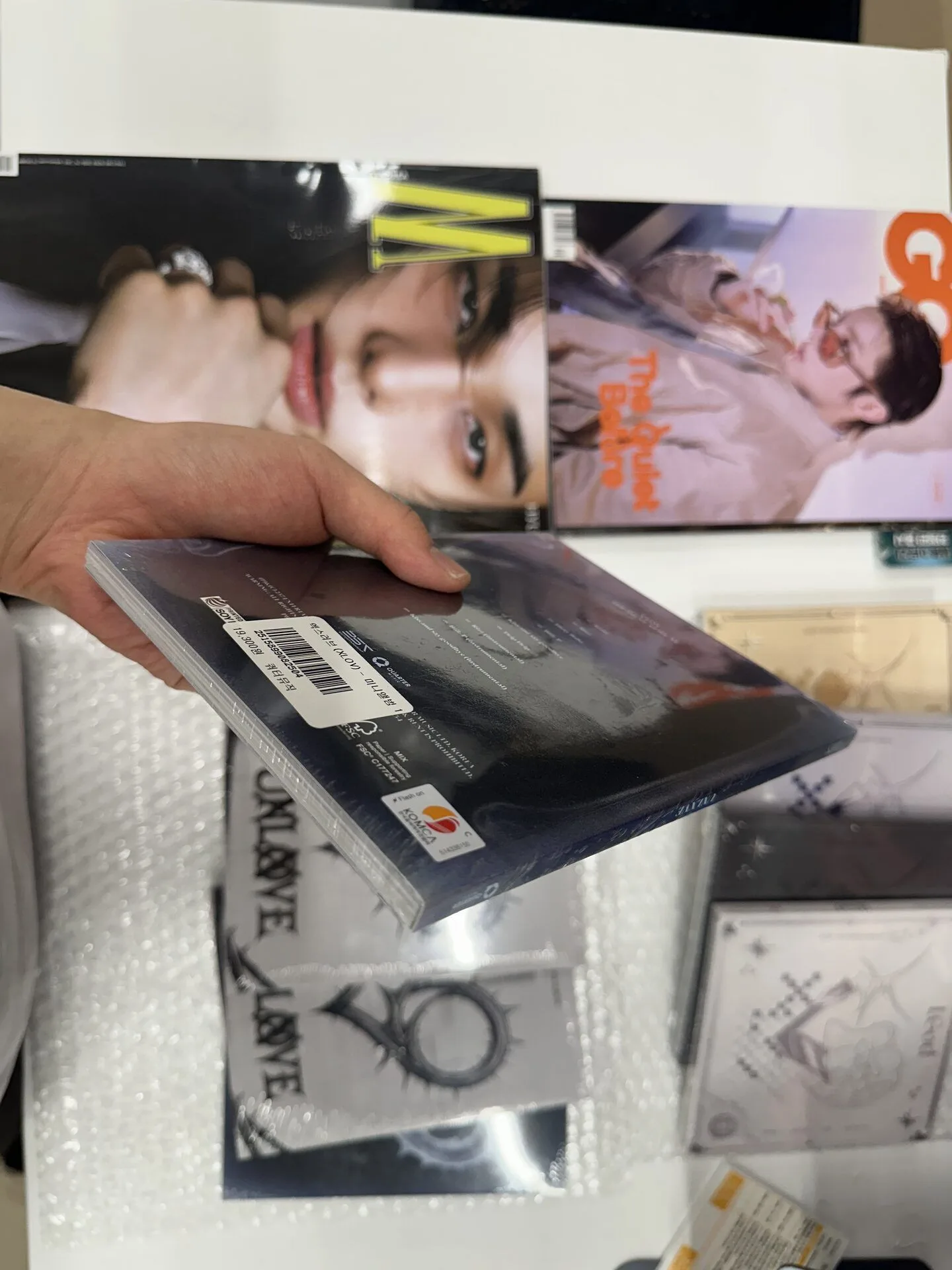 K-pop products individually protected with bubble wrap and blue tape
