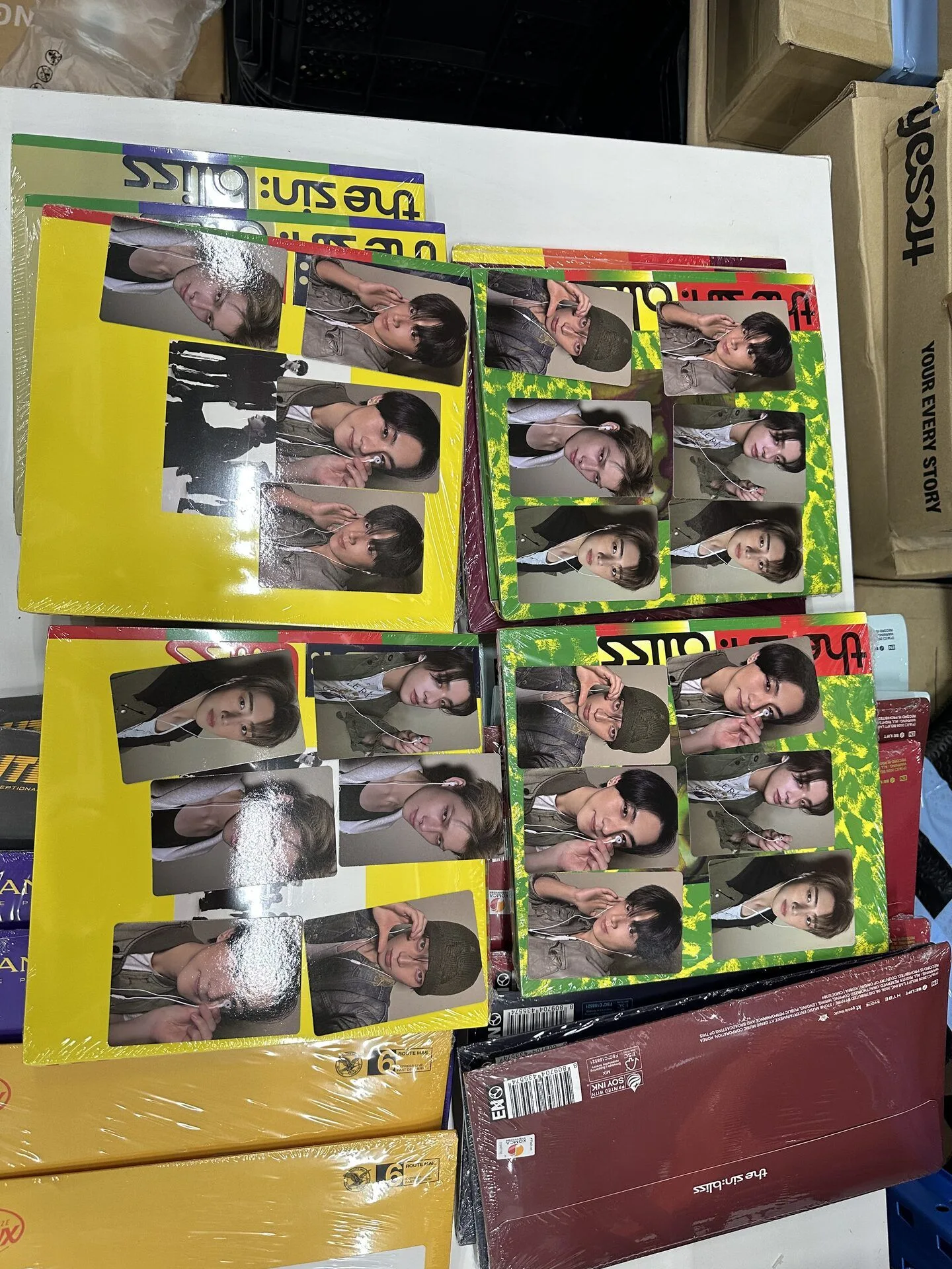 K-pop preorder benefit photocards arranged beside matching albums